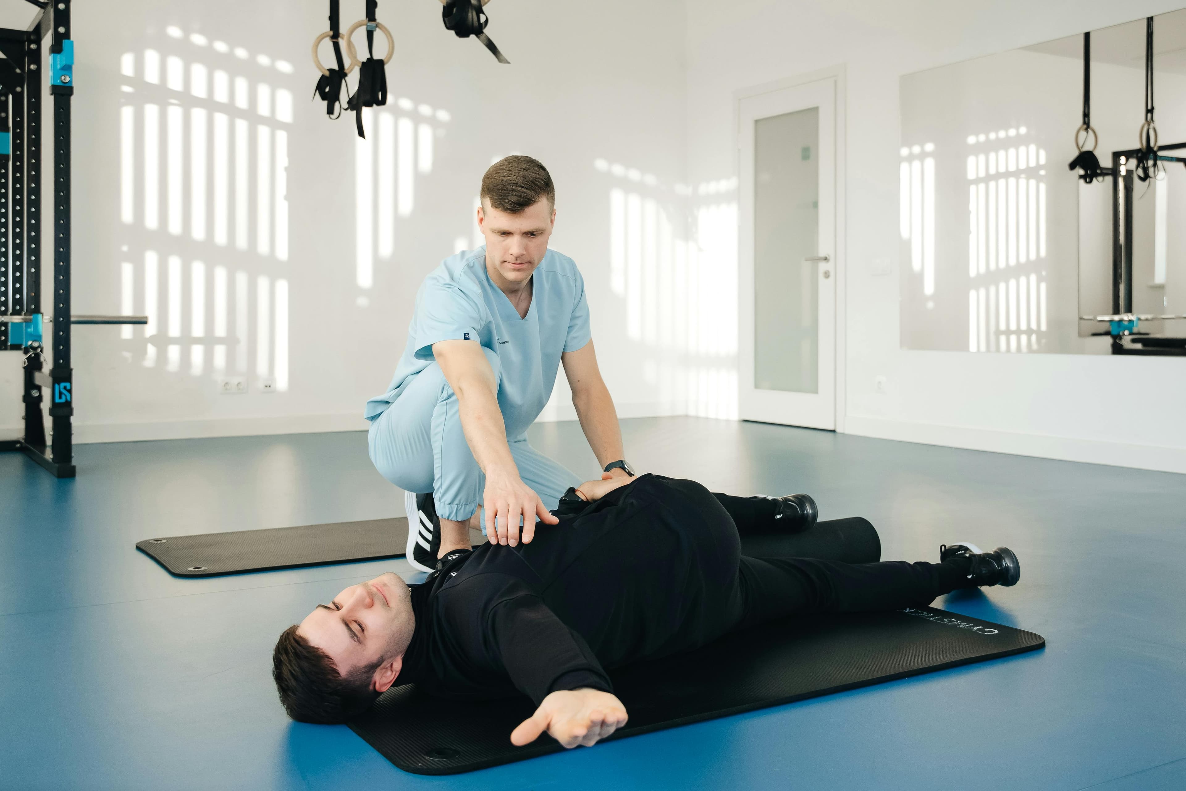 A smiling physiotherapist working with a patient